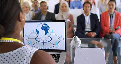 Female speaker adressing the audience at a business conference