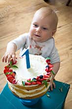 One year old boy and his birthday cake