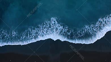 Top view of the desert black beach on the Atlantic Ocean. Coast of the island of Tenerife. Aerial drone footage of sea