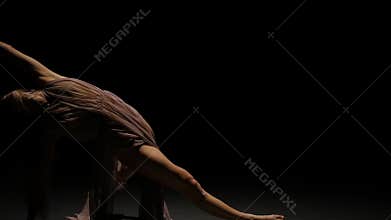 Close-up slow motion of appealing female performing contemp in twilight.