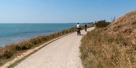 Tourist family in bike vacation on the island of ile d`Aix Charente maritime in web banner template