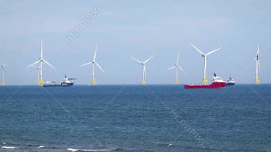 Sea wind farm turbines and ships in Aberdeen, renewable energy. Scotland