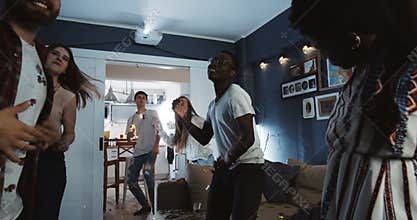 Cheerful multiethnic young college students having epic fun dancing together at party celebrating holidays slow motion.