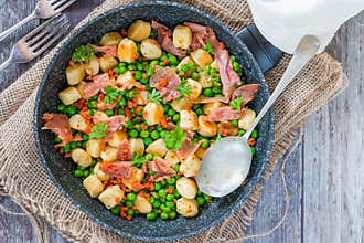 Potato gnocchi with green peas, pesto, proscuitto and chorizo