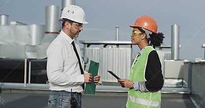 The dazzling young mixed woman explains to the admirable elder man something , after they both shake hands and smile