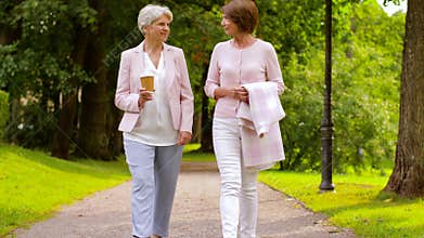 Senior women or friends drinking coffee at park