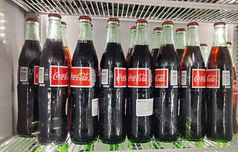 Fridge filled with coca cola bottles. Soft drink 500 ml