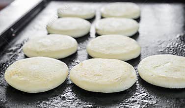 Raw uncooked arepas, traditional Colombian dish, at a street food market