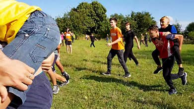 KOROSTEN - AUG, 12, 2019: boys and girls youth teenage christian camps play teambuilding in sunny day. outdoor