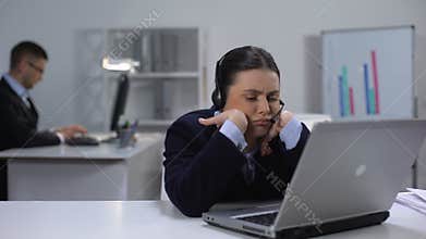 Bored operator in headset at workplace waiting for customer call, telemarketing