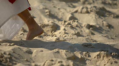 Prophet legs walking on sand, following of Jesus faith, religious conversion
