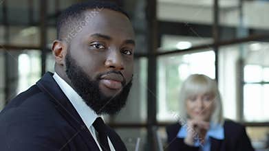 Afro-american male employee looking on camera, racial equality in workplace