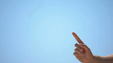 Male hand pointing finger up on sky background, concept of new idea, wise advice