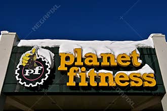 Snow covered Planet Fitness logo