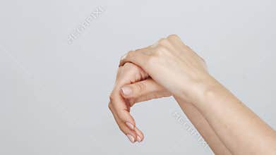 Beautiful female hands studio close-up. Arms of young woman applying cream. Anti-aging, healthcare and rejuvenation.