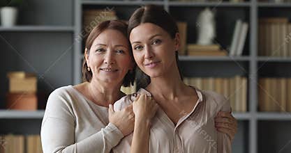 Attractive similar two age generations women family posing for portrait