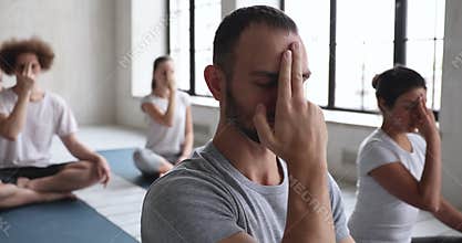 Group of multiracial people do opening the third eye meditation