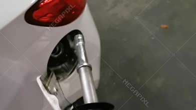 Hand taking the E10 euro 95 fuel dispenser and putting it in the car, eco friendly european fuel, bosschenhoofd, the netherlands,