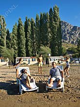 Family relaxing on the sand beach
