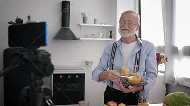Food blogger, elderly Influencers man with glasses for vision and beard writes blog about healthy products and removes