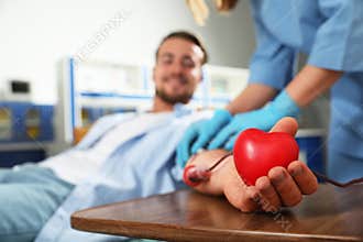 Young man making blood donation in hospital