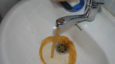 Dirty tap water. Faucet water runs in sink, starts out dirty rusty golden brown.