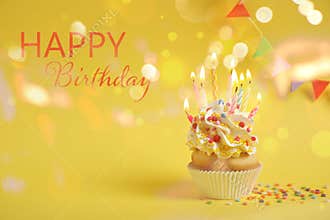 Delicious cupcake with candles on yellow. Happy Birthday