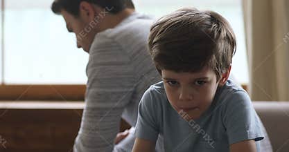 Sad kid son thinking of conflicts turn back to dad