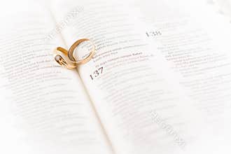old wedding ring between holy Bible page, symbol of loyalty and long marriage