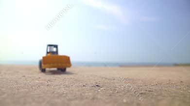 Excavator loader model approaching camera