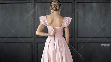 Back view sexy luxury woman posing in evening elegance dress unzipping at vintage studio background