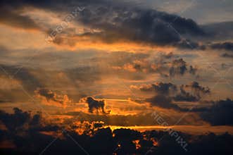 Beautiful sunset with bright red clouds and sunbeams. Abstraction