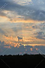 Beautiful sunset with bright red clouds and sunbeams. Abstraction