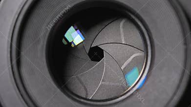 Diaphragm blades of the fixed lens opening and closing aperture f-stop adjustment of a photo camera close-up shot