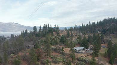 Coming down in front of mountain cliff with houses on the edges in Ashland
