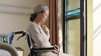 Senior asian woman sitting alone in wheelchair