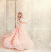 Happy young woman princess dancing in lush vintage pink dress. white royal room. Queen blond hair, golden crown.