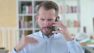 Portrait of Angry Young Man Fighting on Smartphone