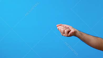 Hand throw coin on blue background