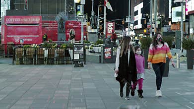 New York City, USA - April 14, 2020 People in medical masks on the streets of New York. People walk in Times Square in