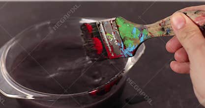 Footage of dirty paint brush being cleaned