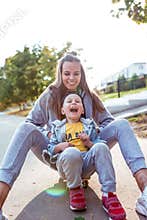 Young family, mother woman, little boy 3-5 years old son, in summer in city. Screaming having fun from tickling, happy