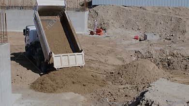 Dump truck emptying a load of dirt
