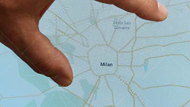 Close up hand gesture on touch screen zoom in Milan city Italy