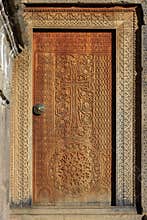 Door with carved hand-made elements, cross, circle