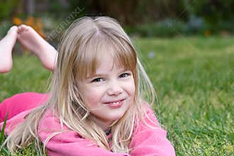 Little girl lying in grass