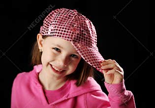 Female child wearing pink sparkly baseball cap