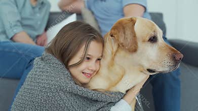 Close-up of teen girl embracing dog at home