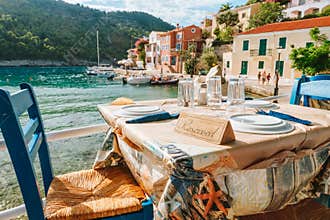 Reserved table in Greek tavern in Assos fishing village, Kefalonia island, Greece