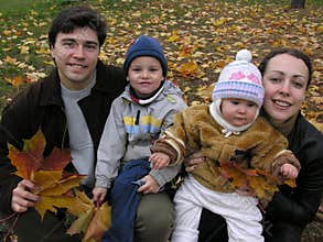 Faces family of four on maple leaves